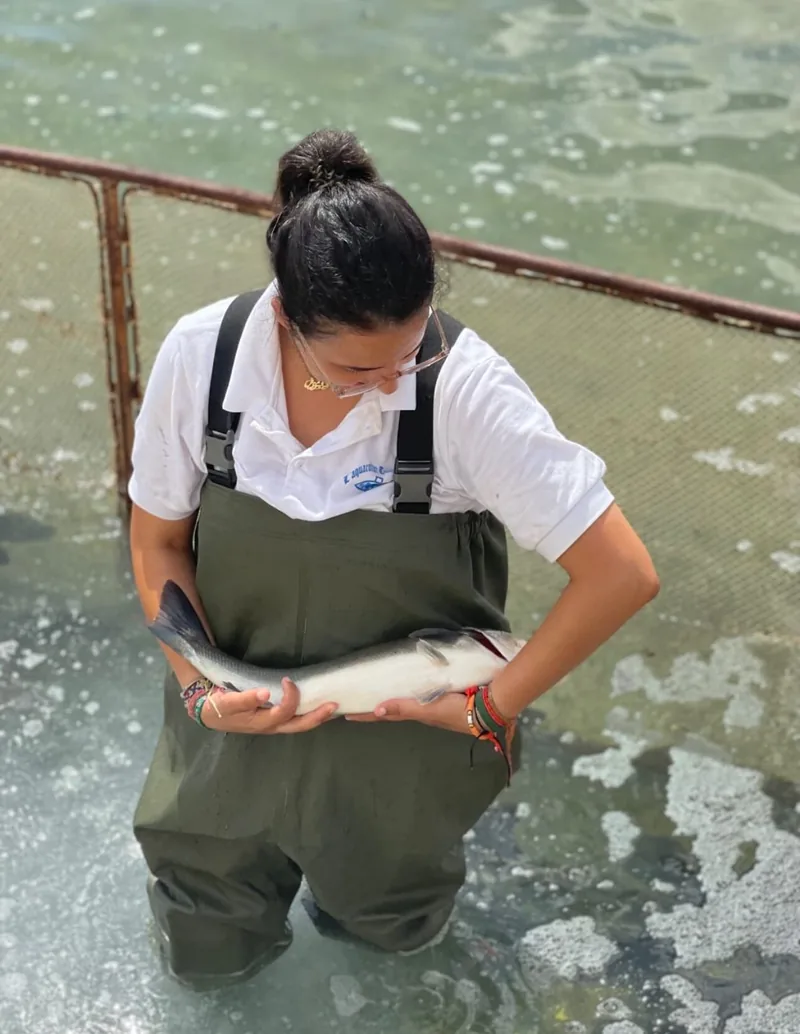 A woman holding a fish.