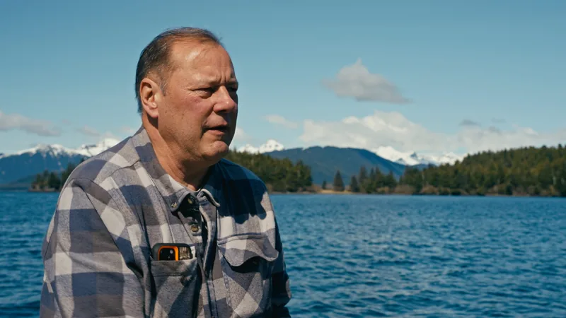 A man sitting on the deck of a boat.