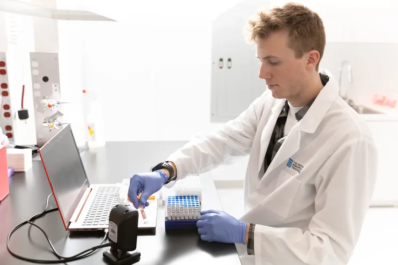 A man in a lab coat at work in a laboratory