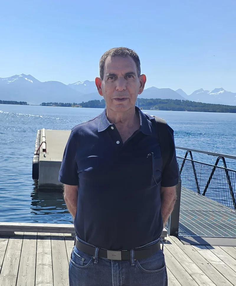 A man standing in front of the sea.
