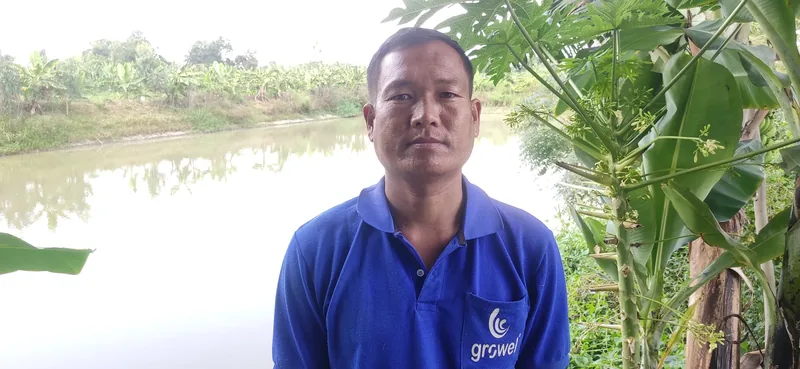 a man standing in front of a pond
