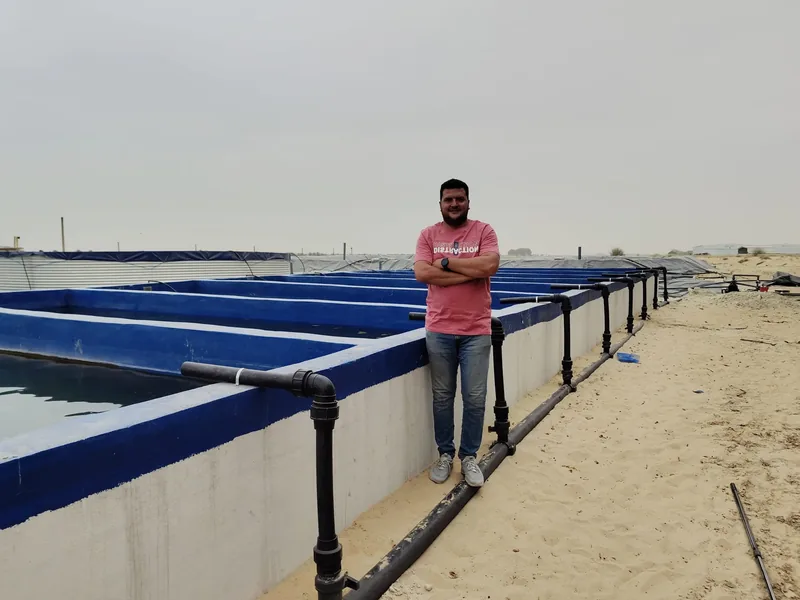 Man standing next to a farm.