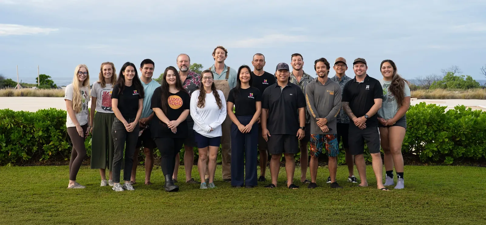 A group team photo of a company which works on cultivating red seaweeds.