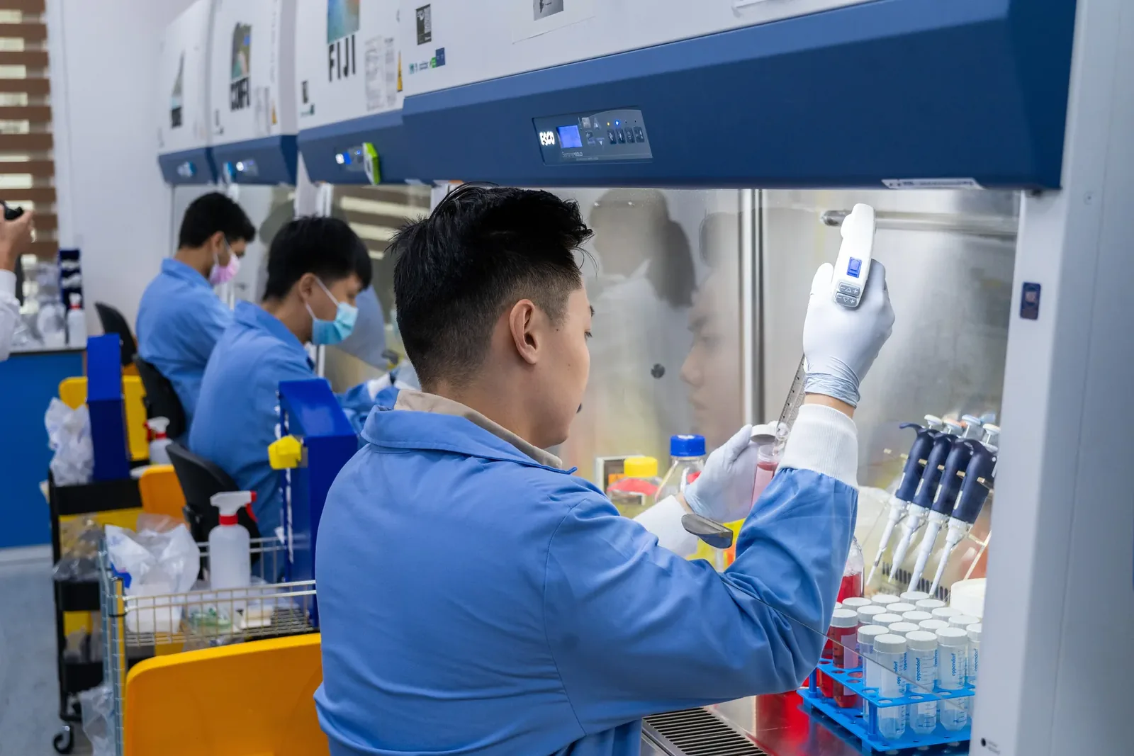 Three people working in a lab.